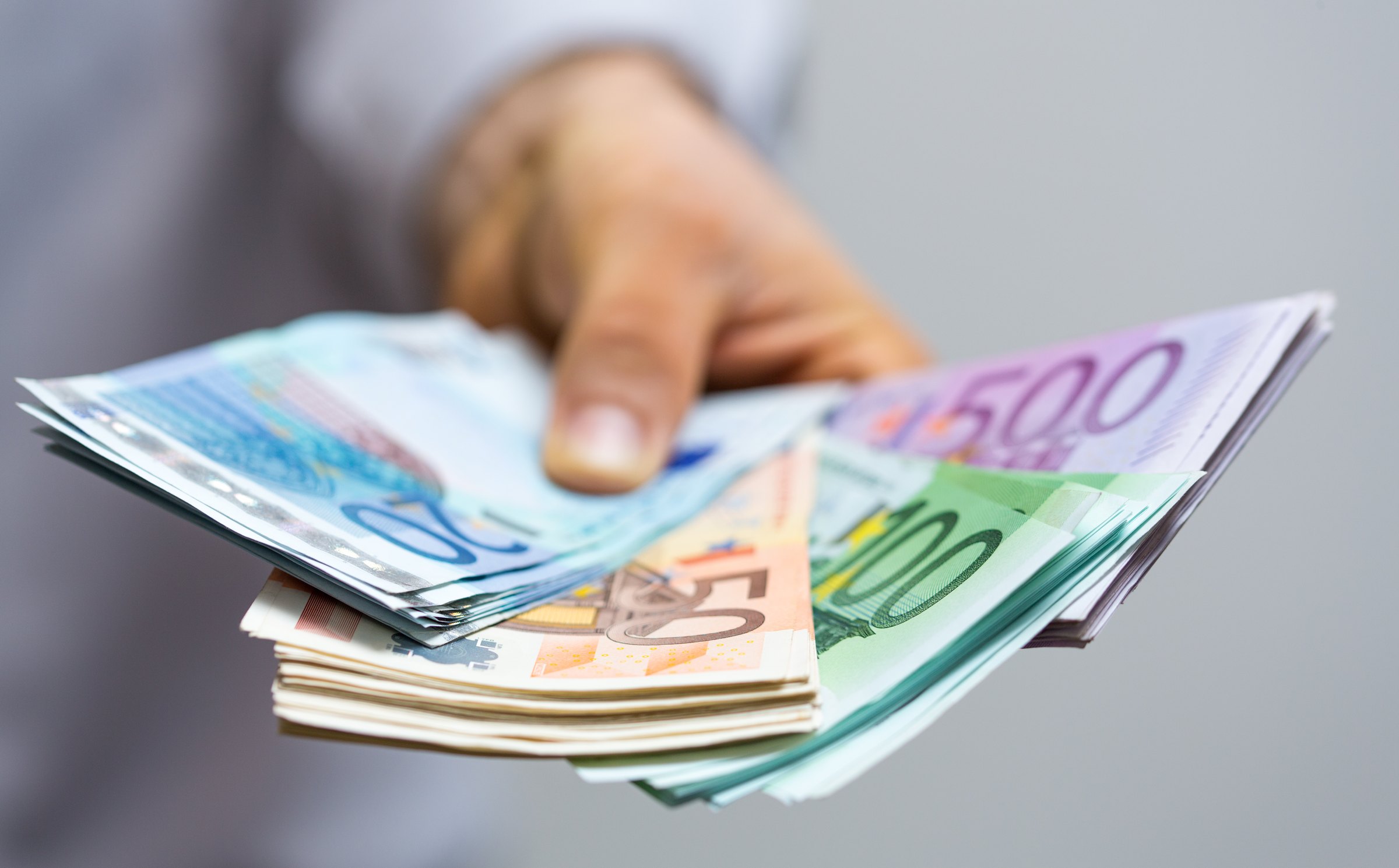 Hand hält aufgefächerte Euro-Geldscheine
